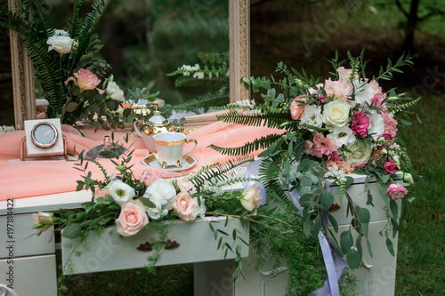 A wedding bouquet lies on a dressing table. Morning of the bride. Scenery. photo