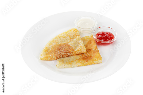 Photos Two pancakes triangle with berry jam and sour cream, isolated white background on a plate