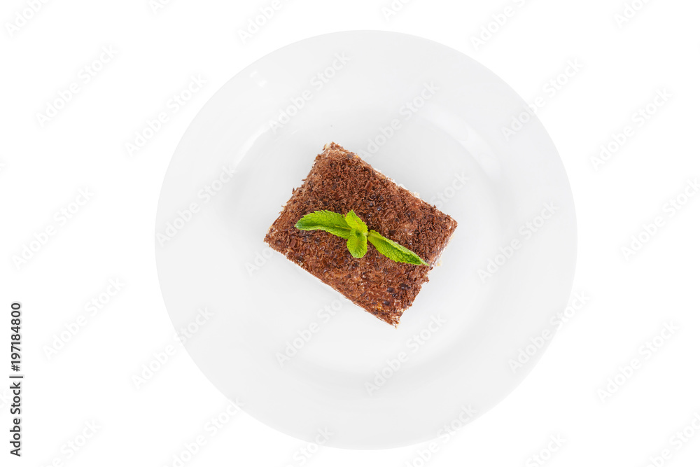 Rectangular piece of Tiramisu with a sprig of mint on a white plate. isolated on white background. Dessert for a menu in a cafe, restaurant, coffee shop view from above Rectangular piece of Tiramisu with a sprig of mint on a white plate. isolated on white background. Dessert for a menu in a cafe, restaurant, coffee shop view from above