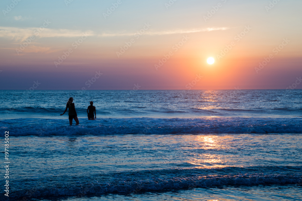 Silhouettes of people enjoying the sunset on the atlantic ocean, Lacanau France