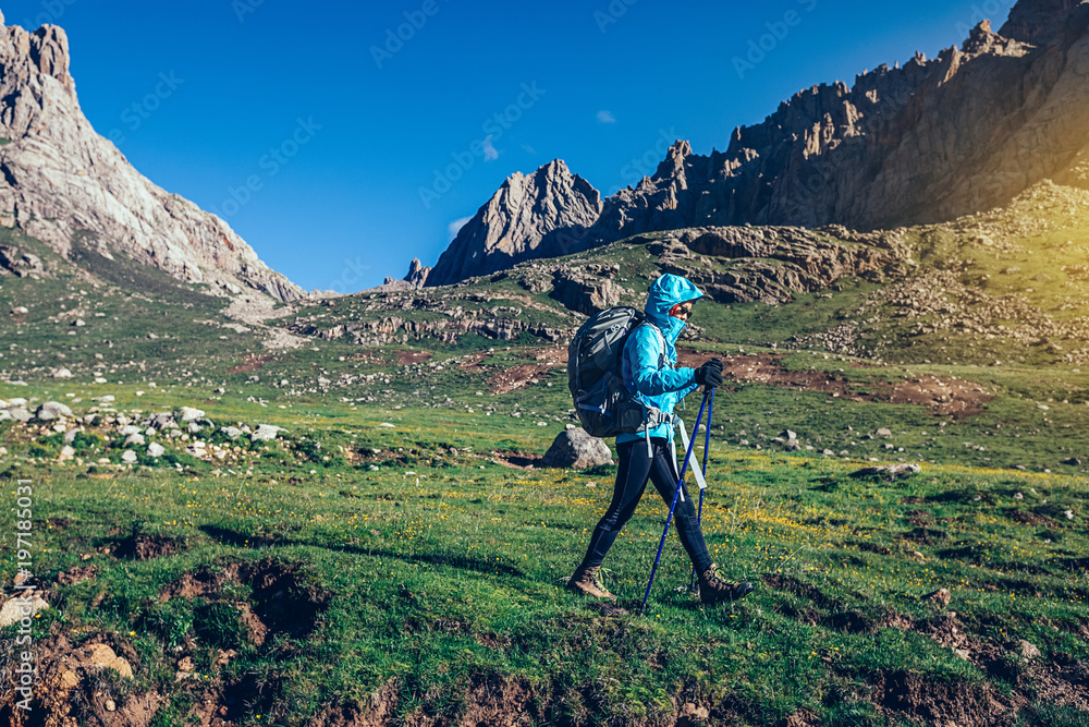 Fototapeta premium backpacking woman hiker walking on beautiful mountains