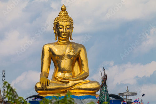 sitting golden big Buddha statue at Golden Triangle at view point of Kong river in Chiang Rai Thailand