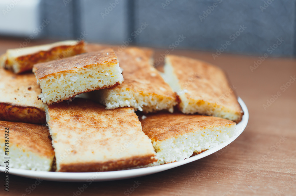 beautiful casserole on a plate of Golden-colored cottage cheese sweet tasty beautiful casserole on a plate of Golden-colored cottage cheese sweet tasty