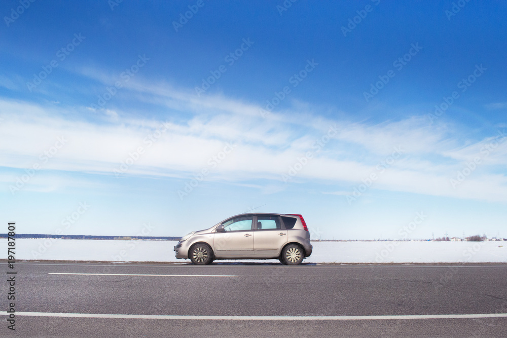 in a beautiful sunny day beige car parked at the side of the highway in a beautiful sunny day beige car parked at the side of the highway