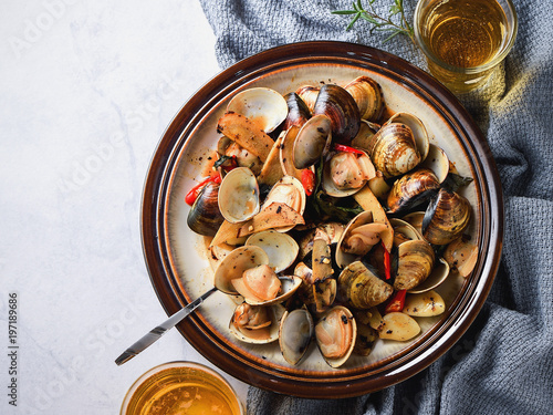 Stir-frying Ginger and clams at high heat to bring forth the savory aroma with sesame oil in recipe