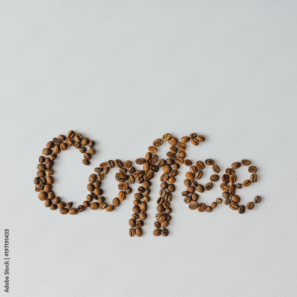 Word Coffee made of coffee beans on bright background with copy space. Flat lay concept. Word Coffee made of coffee beans on bright background with copy space. Flat lay concept.