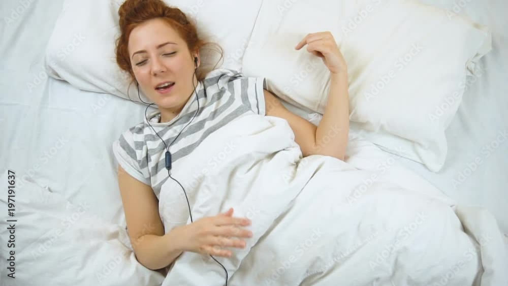 Attractive young foxy woman playing imaginary guitar while sleeping Attractive young foxy woman playing imaginary guitar while sleeping