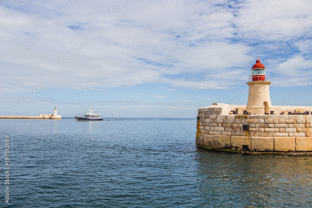 A ship between Ricasoli Breakwater Light and St. Elmo Breakwater Head Light, Valletta, Malta