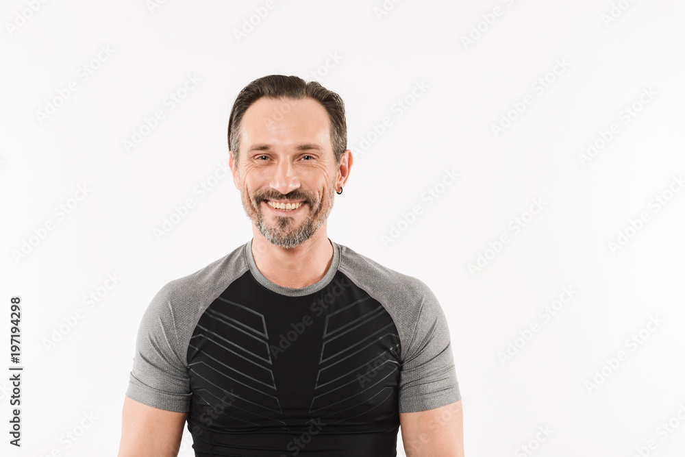 Portrait of happy caucasian man 30s wearing sportswear posing on camera with smile and satisfied look after fitness or practising, isolated over white background Portrait of happy caucasian man 30s wearing sportswear posing on camera with smile and satisfied look after fitness or practising, isolated over white background
