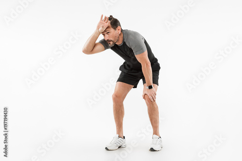 Portrait of an exhausted mature sportsman resting