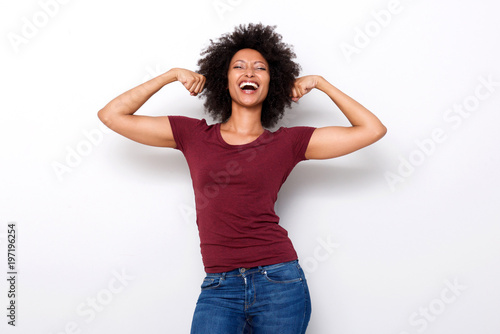 Slika na platnu healthy young african woman flexing both arms muscles on white background