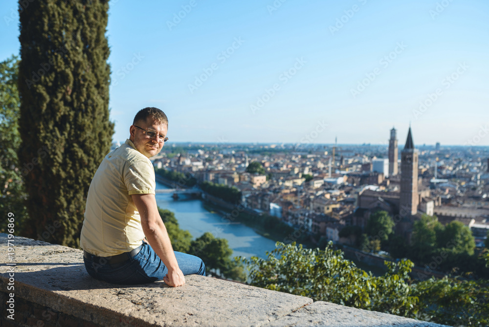 Man Sitting on Fence with Great View