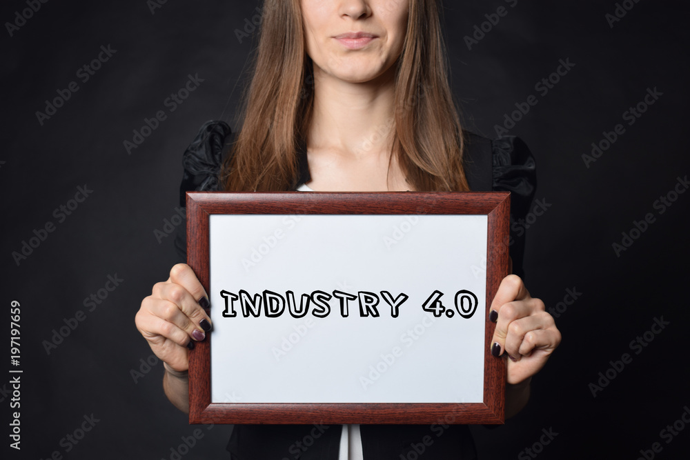 In the hands of a businessman a frame with the inscription:INDUSTRY 4.0 In the hands of a businessman a frame with the inscription:INDUSTRY 4.0
