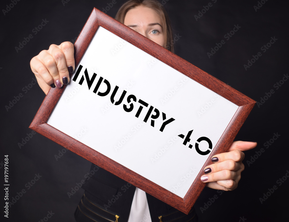 In the hands of a businessman a frame with the inscription:INDUSTRY 4.0 In the hands of a businessman a frame with the inscription:INDUSTRY 4.0