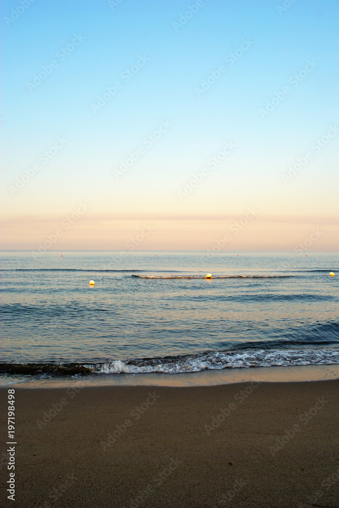summer sea, early morning on the beach, romantic pink sunrise, vertical