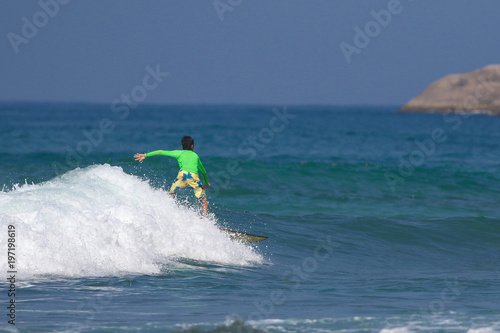 Young boy surfing on ocean waves