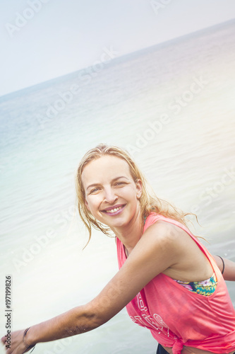 Relaxed fitness woman is happy at the beach