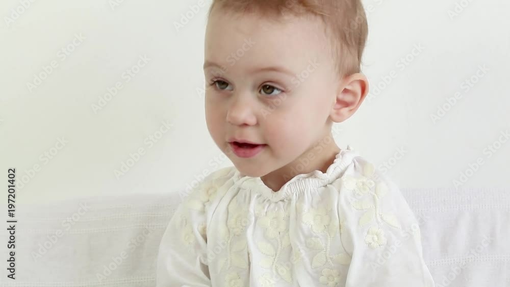 Cute baby girl talking and making funny faces while playing