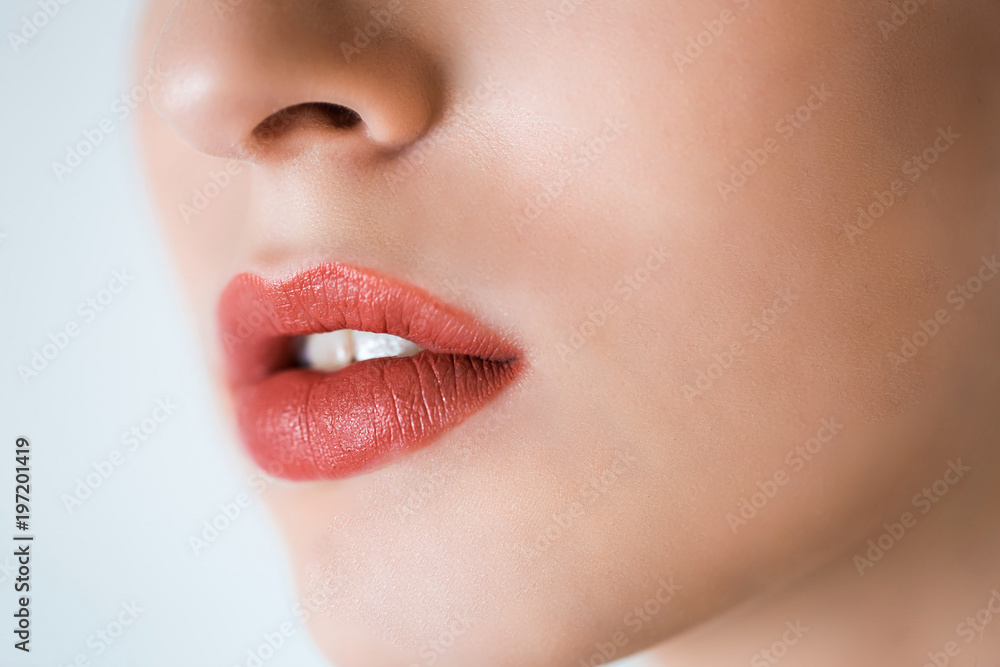 Professional makeup. Lipgloss. Closeup portrait of beautiful girl with colorful red lips and lipstick. Caucasian young woman model with bright makeup with perfect clean skin Professional makeup. Lipgloss. Closeup portrait of beautiful girl with colorful red lips and lipstick. Caucasian young woman model with bright makeup with perfect clean skin