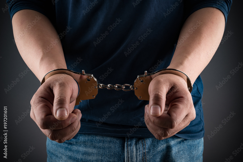 arrested man in handcuffs with hands in front arrested man in handcuffs with hands in front