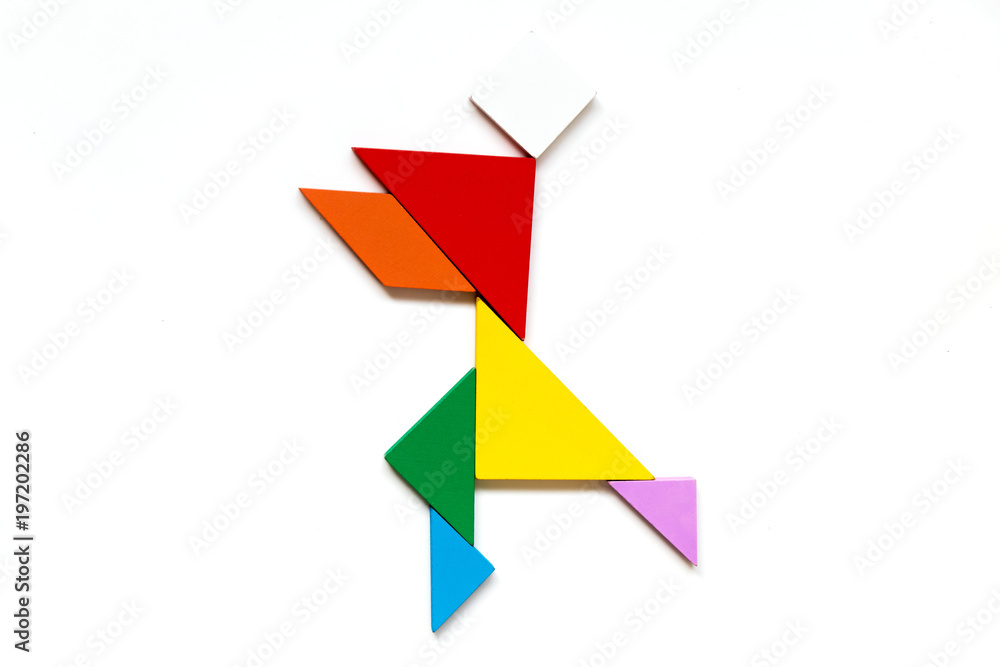 Color wood tangram puzzle in running man shape on white background Color wood tangram puzzle in running man shape on white background