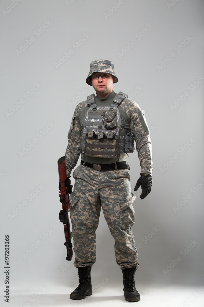 Full-length picture of military man in helmet with gun Full-length picture of military man in helmet with gun
