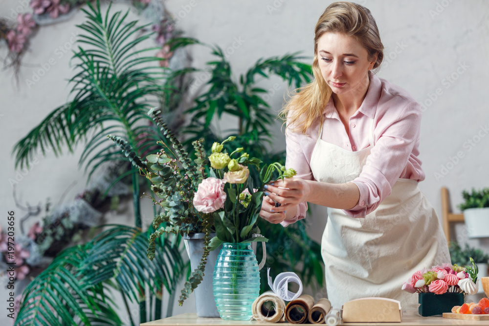 Professional florist working in flower shop. Stock Photo | Adobe Stock