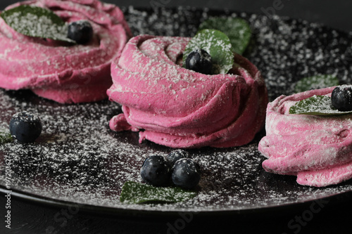 Canvas Print Pink homemade zephyr or marshmallow,  meringue in a plate on a black background