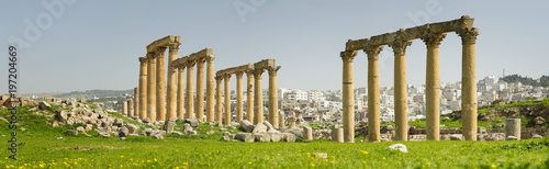 ruins of old columns on the green hill in Jordan
