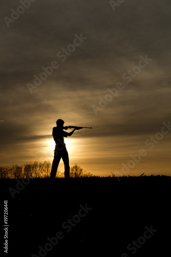 small game hunter in the sunset 