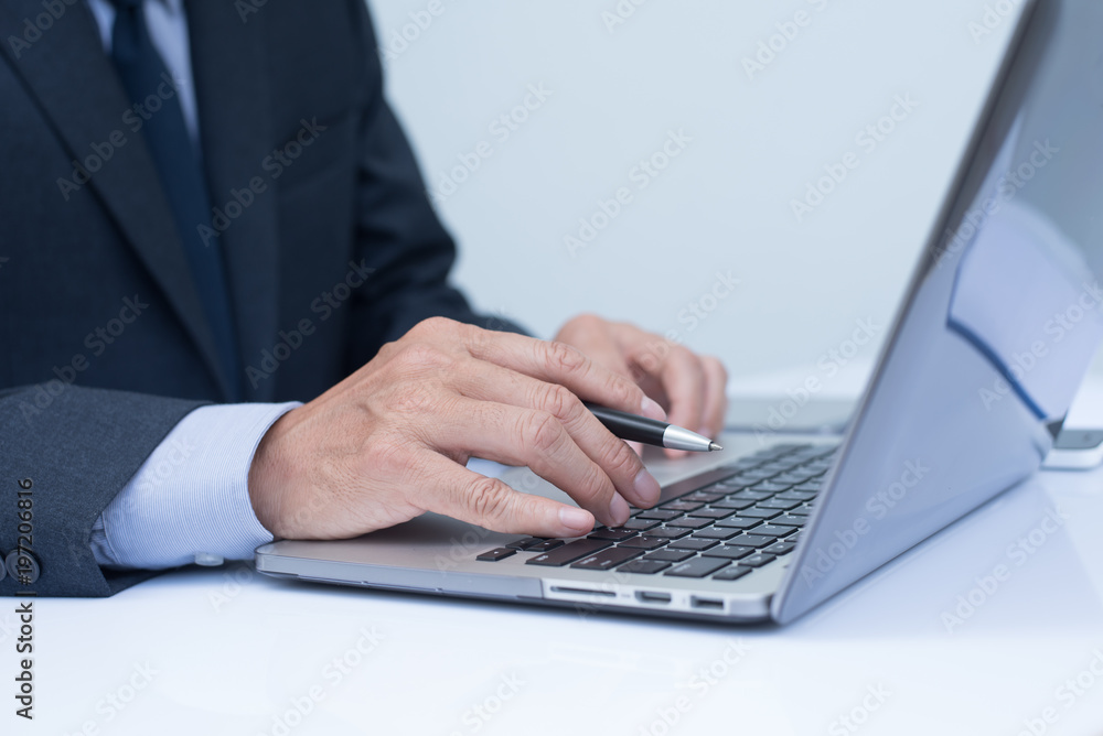 Businessman working on laptop computer Businessman working on laptop computer