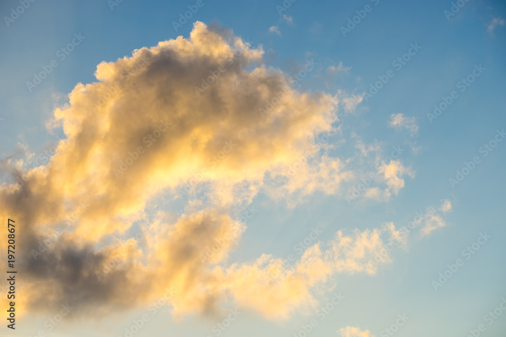 Yellow cloud with blue sky during sunset.