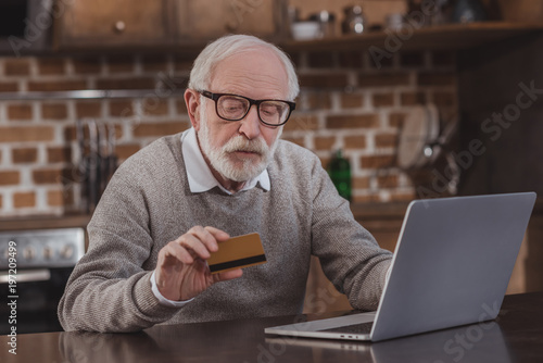 handsome grey hair man shopping online at home