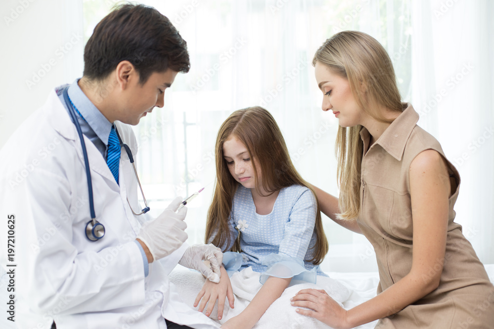 Fototapeta premium Girl scary to injection from doctor at hospital. People with medical and health care concept.