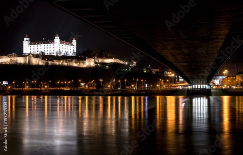 Horizontal Night Image of Bratislava City view, including Bratislava Castle, UFO Bridge over Danube River. Captured in Bratislava, Slovakia, Central Europe 3/29/2018