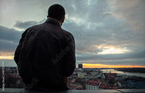 Bratislava, Slovakia - March 17, 2018: Silhuette picture of an unrecognizable man over the city during the sunrise