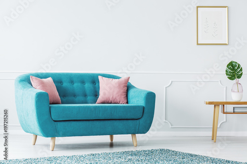 Turquoise sofa in minimalist interior