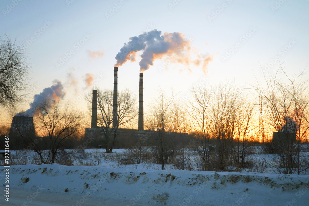 Smoke from factory chimneys on background of sunset sky Smoke from factory chimneys on background of sunset sky