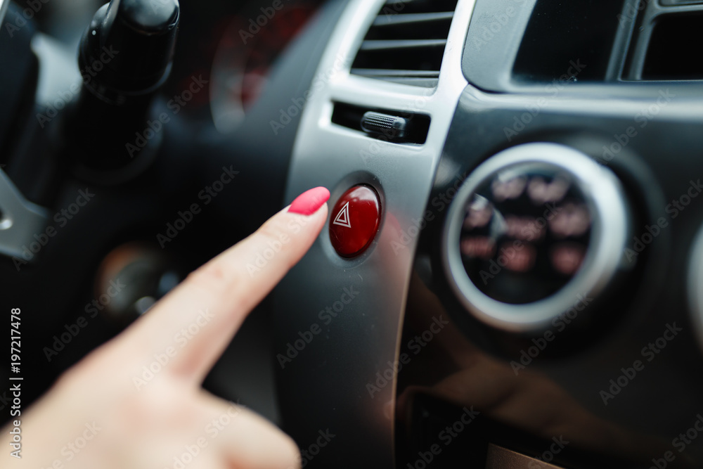 The female hand presses the button to turn the alarm into the car.