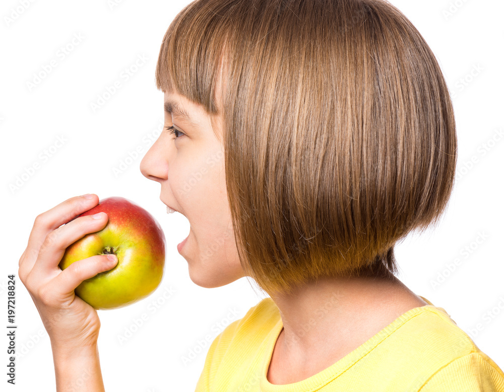 Portrait of little girl with fresh apple. Beautiful child wearing yellow t-shirt, holding fruit. Happy cute child on white background - close-up. Portrait of little girl with fresh apple. Beautiful child wearing yellow t-shirt, holding fruit. Happy cute child on white background - close-up.