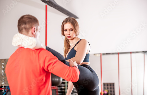 Fit couple stretching before training at fitness gym