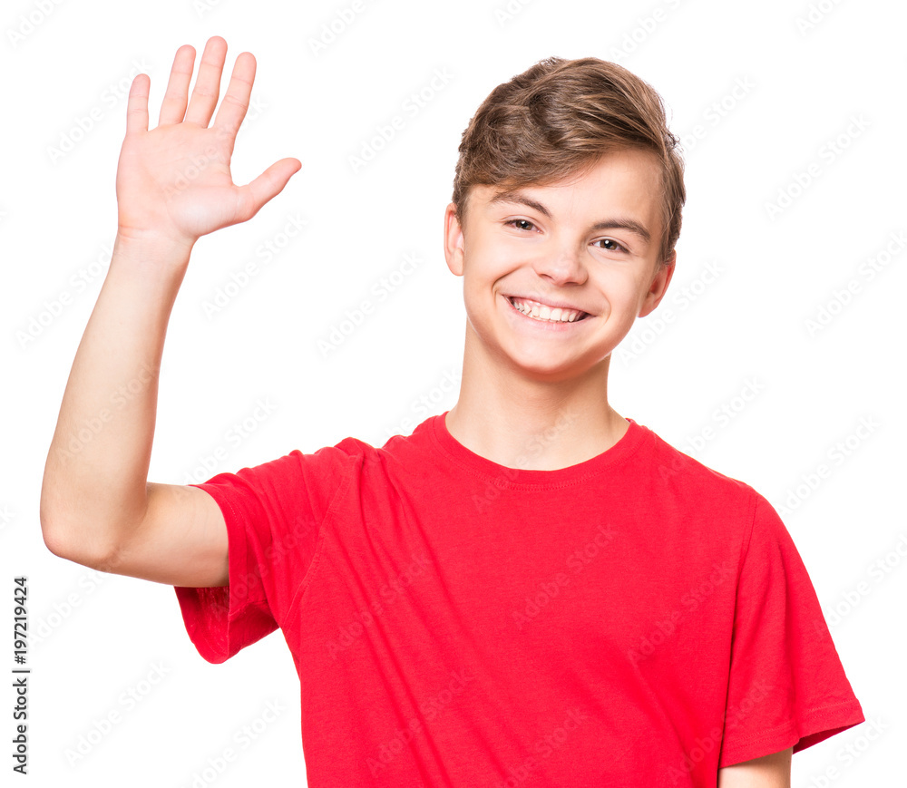 Emotional portrait of caucasian smiling teen boy wearing red t-shirt,  stretching his right hand up for greeting. Happy child waving hand,  isolated white background. Stock Photo | Adobe Stock