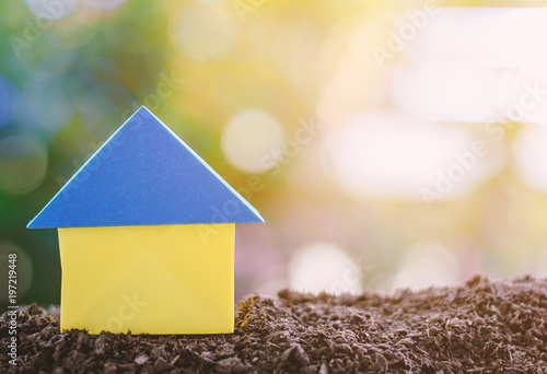 Paper house origami on soil...