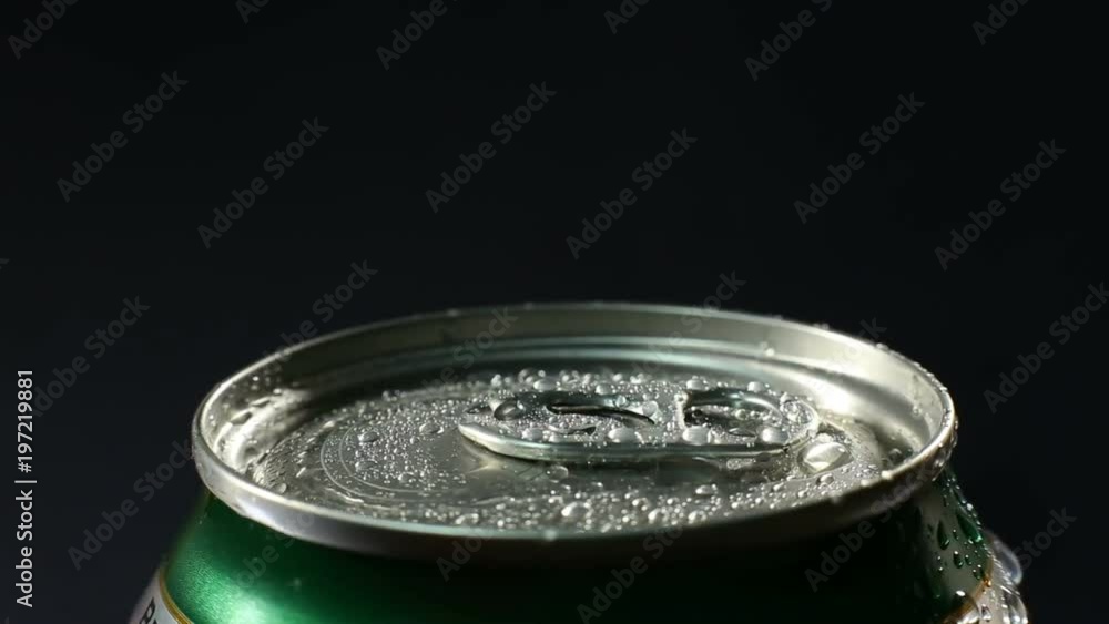 Water droplets on aluminium can of soda or beer. A cold drink rotates against a black background. Water droplets on aluminium can of soda or beer. A cold drink rotates against a black background.