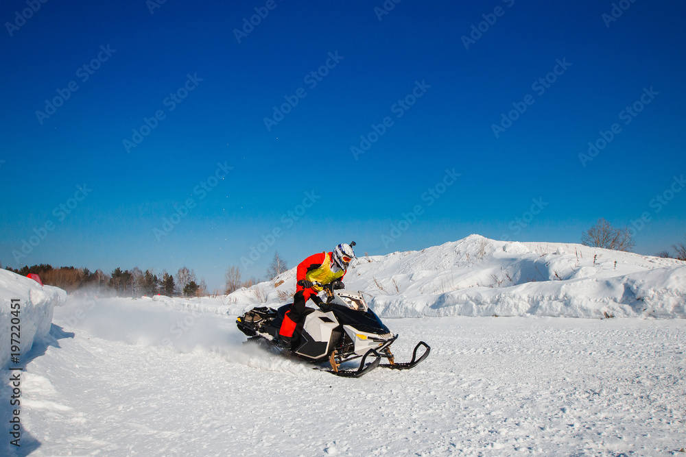 Snowmobile. Snowmobile races in snow. Concept winter sports, racers. Snowmobile. Snowmobile races in snow. Concept winter sports, racers.