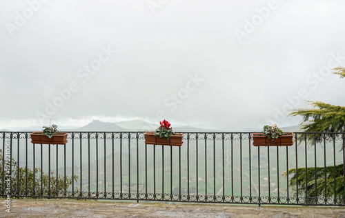 Obraz na plátne Balcony with a panoramic view of the low clouds located in the small Sicilian town Gangi