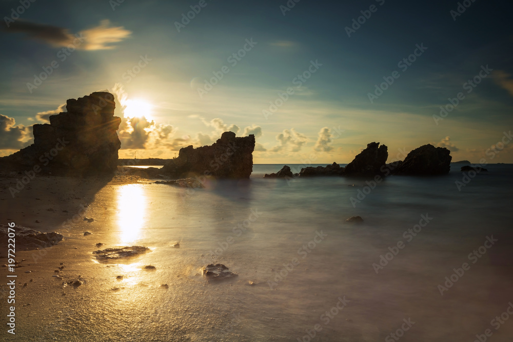 Sunrise seascape with natural stone arch