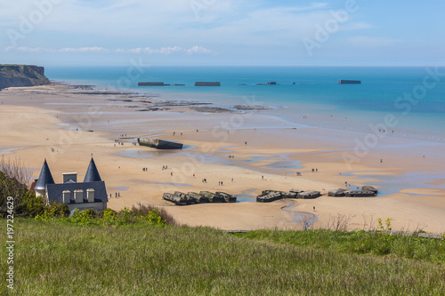Arromanches-les-Bains beach with the remains of the Mulberry harbour in Normandy, France