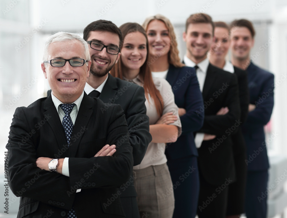 senior businessman standing in front of his business team senior businessman standing in front of his business team