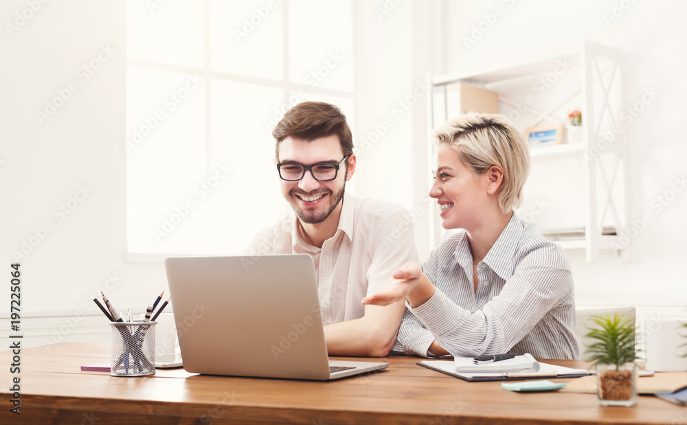 Couple of young colleagues working at modern office Couple of young colleagues working at modern office